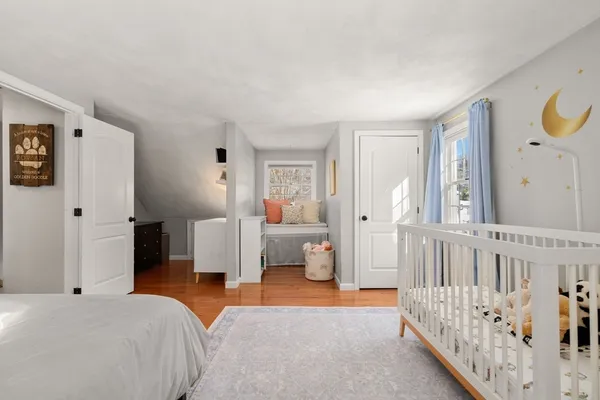 a bedroom with furniture and baby crib