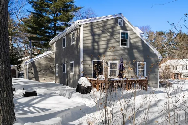 a view of a house with a yard patio and fire pit