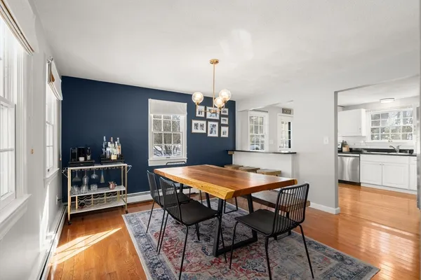 a dining hall with a dining table and chairs with wooden floor