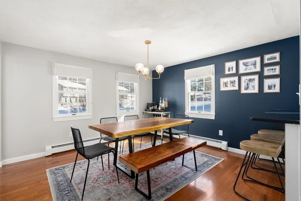 a room with furniture a desk and chair with wooden floor