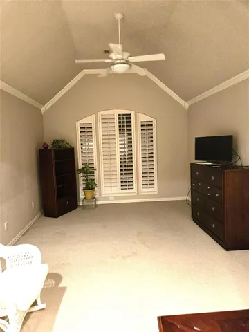 a bedroom with a bed and a television