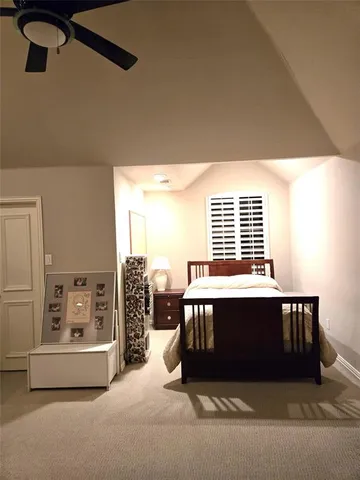 a spacious bedroom with a bed and window