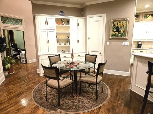 a dining room with furniture a rug and wooden floor