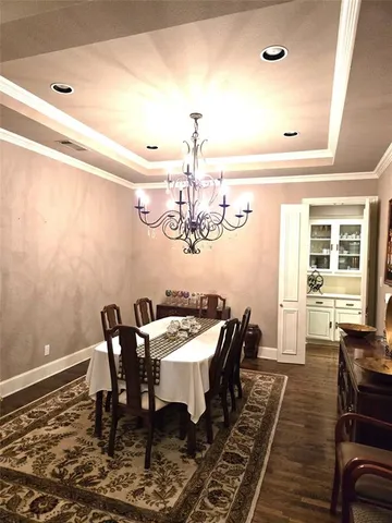 a dining room with furniture a rug and wooden floor