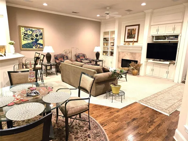 a living room with furniture a flat screen tv and kitchen view