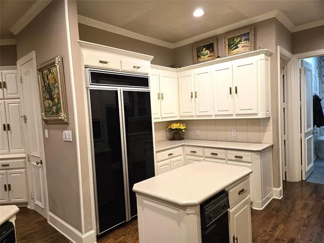 a kitchen with stainless steel appliances a stove a refrigerator and cabinets