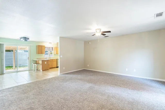 an empty room with a kitchen and a sink