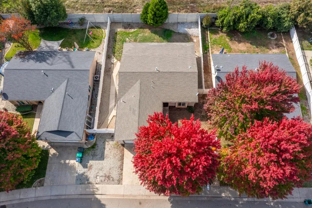 an aerial view of a house with a yard and garden