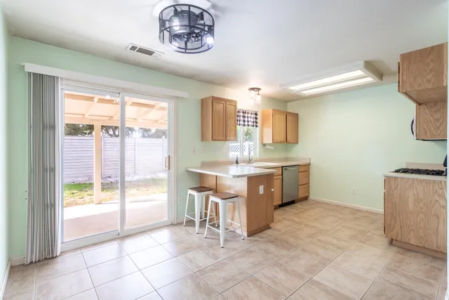 a kitchen with a stove a sink and a refrigerator