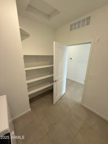 a large bathroom with a granite countertop sink a toilet and a mirror