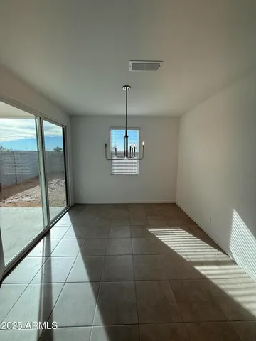 a large kitchen with stainless steel appliances kitchen island a large counter top and a refrigerator