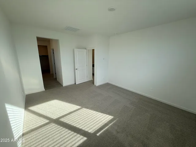 a spacious bathroom with a double vanity sink and mirror