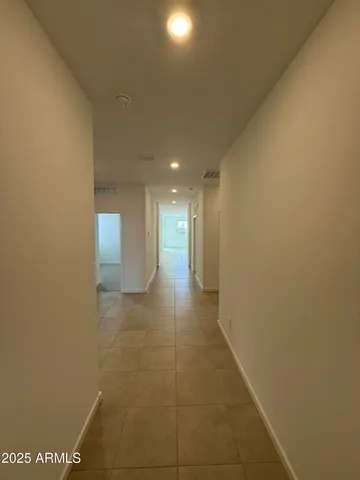 a view of hallway with bathroom