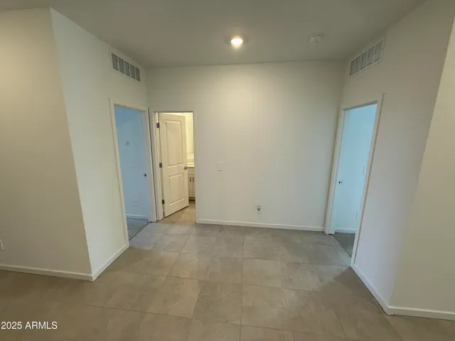 an empty room with closet and wooden door