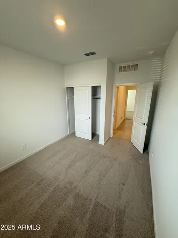 a view of hallway with wooden floor