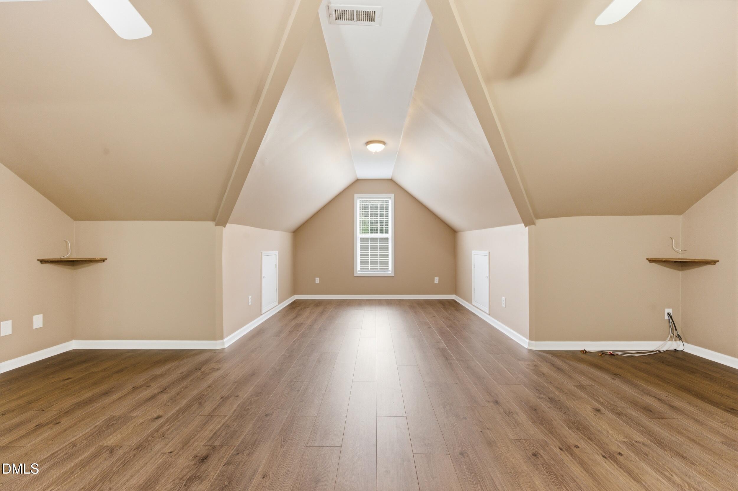 125 Rustic Lane Smithfield, NC 27577 - Photo 33 of 49 a view of an empty room with wooden floor and a window