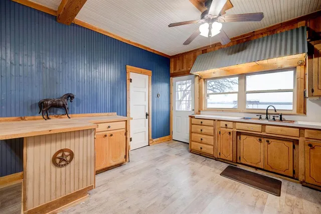 a view of a kitchen with a sink and windows