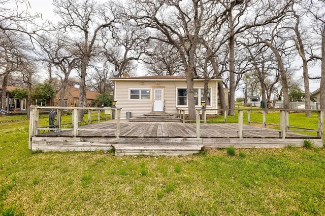 a view of a house with swimming pool and a yard