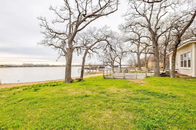 a view of yard with swimming pool and trees