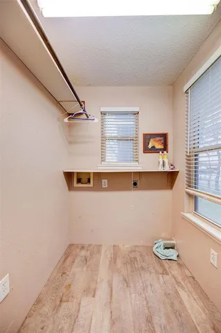 a view of storage and utility room with a window