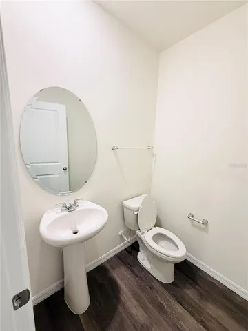a bathroom with a sink toilet and a mirror