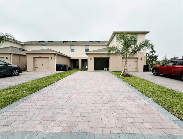 a view of a white house with a outdoor space