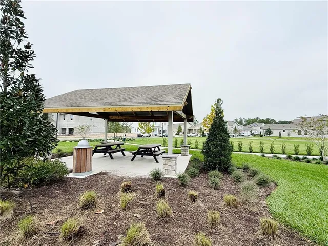 a view of a grassy field with trees