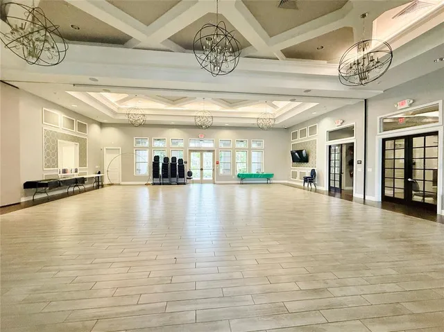 a living room with furniture a flat screen tv and a large window