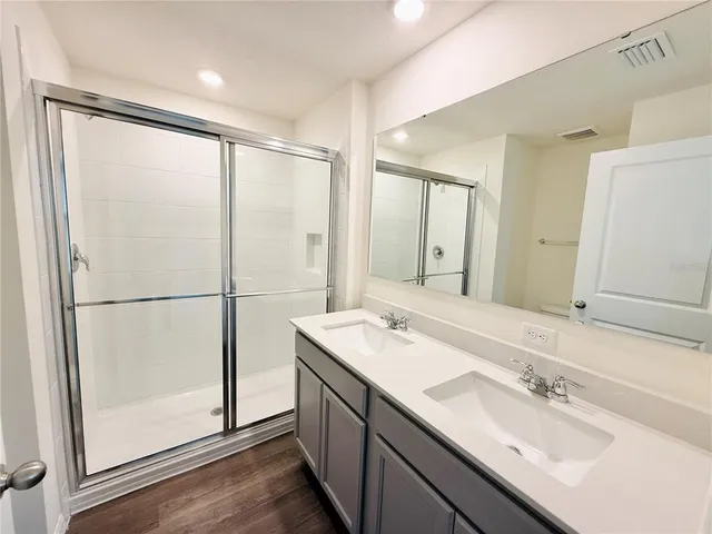 a bathroom with a double vanity sink mirror and double