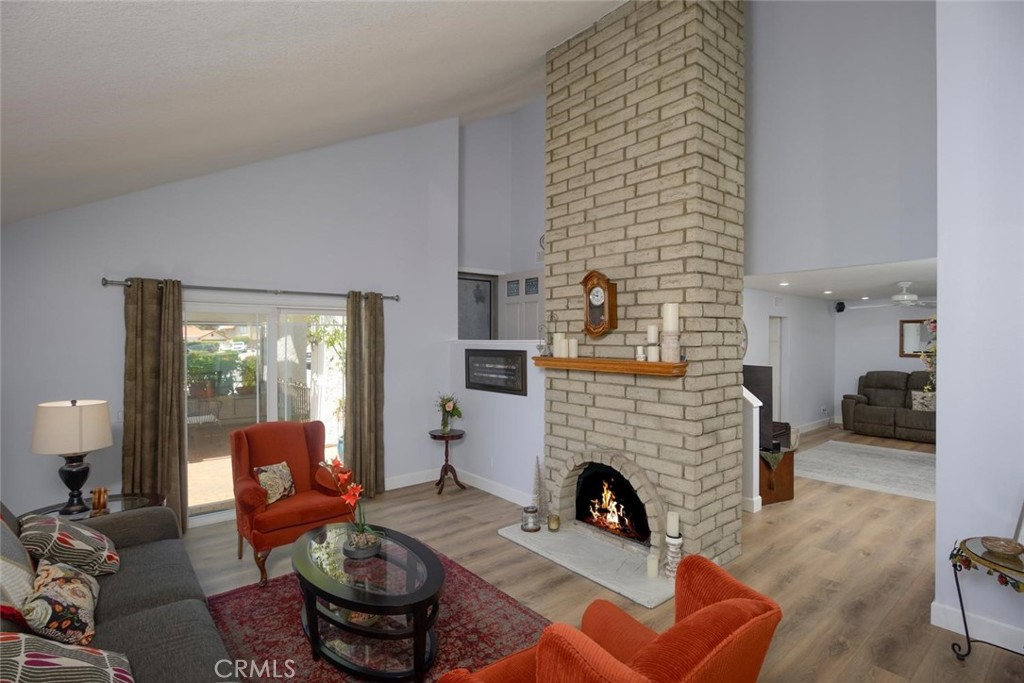 10424 Cartilla Court Rancho Cucamonga, CA 91737 - Photo 3 of 36 a living room with furniture a fireplace and a large window