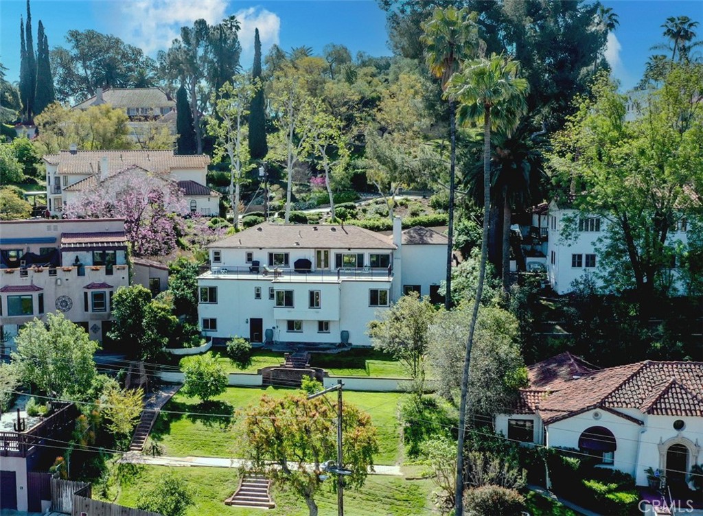 4680 Ladera Lane Riverside, CA 92501 - Photo 1 of 1 a large building with a big yard plants and large trees