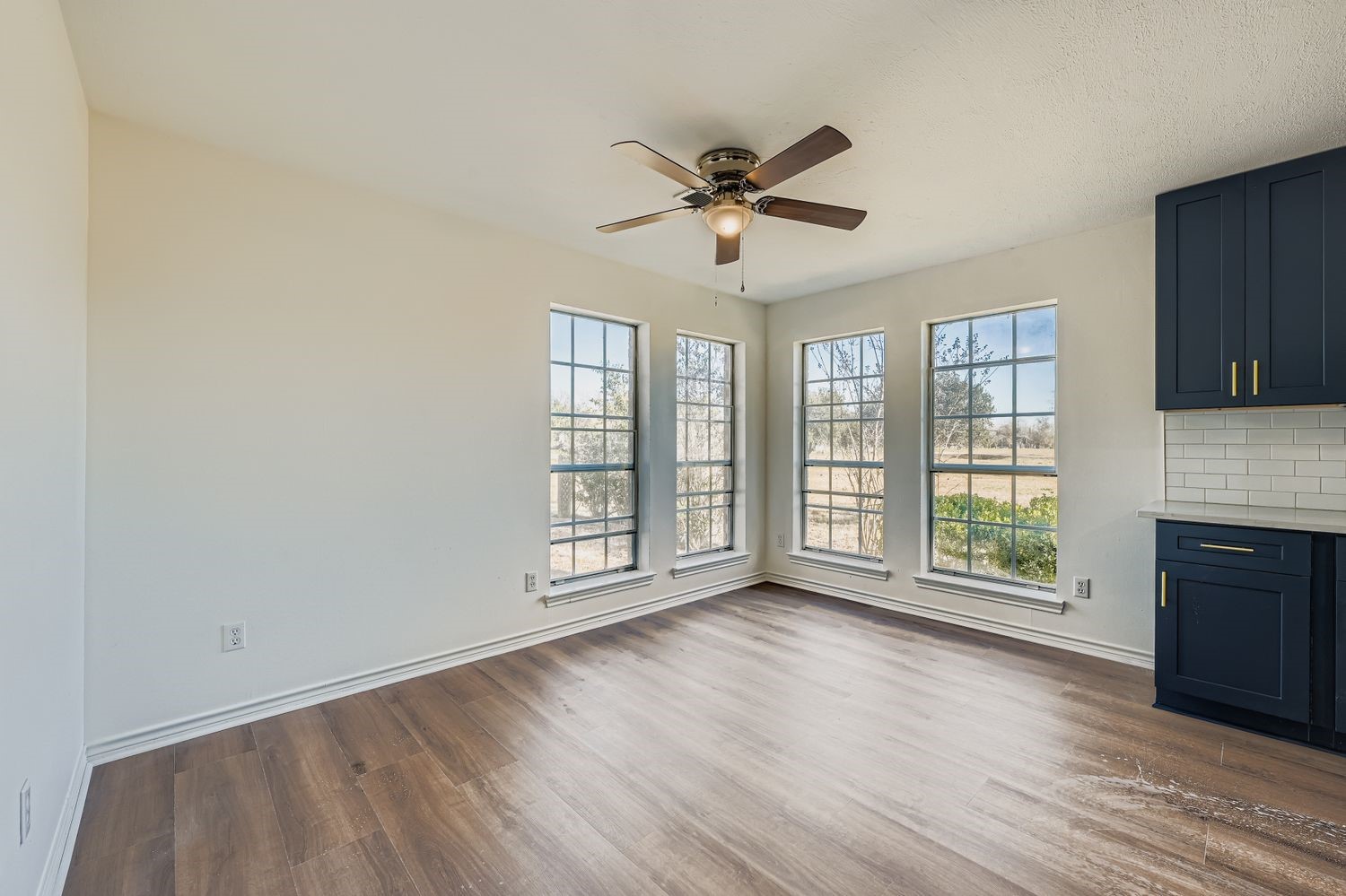 34411 Fulshear Farms Road Fulshear, TX 77441 - Photo 12 of 29 a view of an empty room with a window and wooden floor