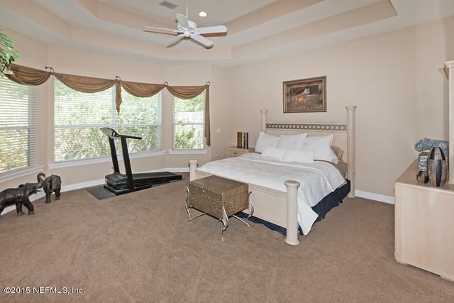 11766 Mandarin Road Jacksonville, FL 32223 - Photo 11 of 20 a bedroom with a bed a couch and a large window