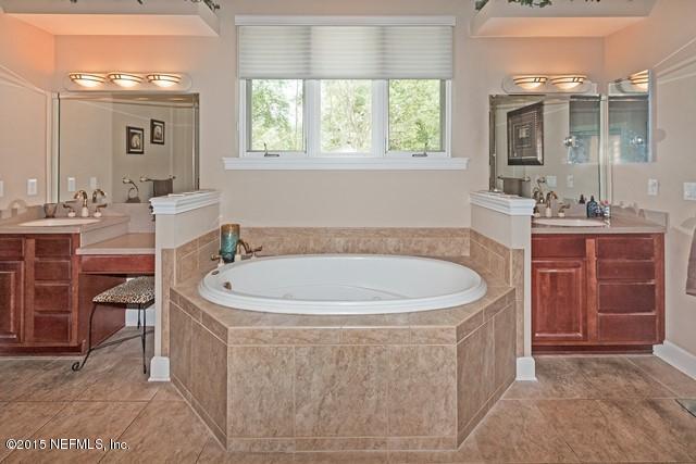 11766 Mandarin Road Jacksonville, FL 32223 - Photo 12 of 20 a spacious bathroom with a bathtub and a sink