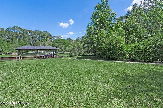 11766 Mandarin Road Jacksonville, FL 32223 - Photo 19 of 20 a view of a garden with a bench in the background