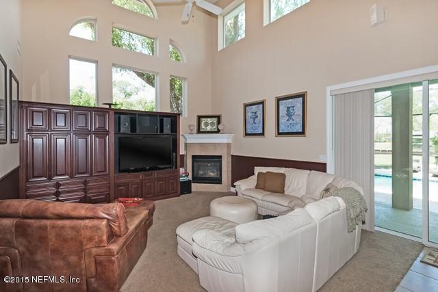 11766 Mandarin Road Jacksonville, FL 32223 - Photo 10 of 20 a living room with furniture and a flat screen tv
