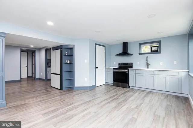 a kitchen with a refrigerator and a stove top oven