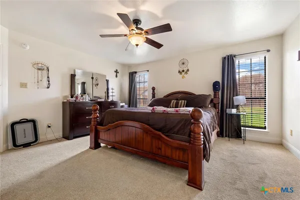 a bedroom with a bed and ceiling fan