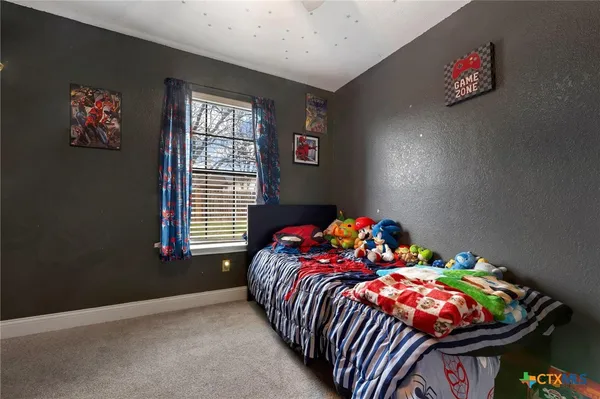 a bedroom with bed and a window