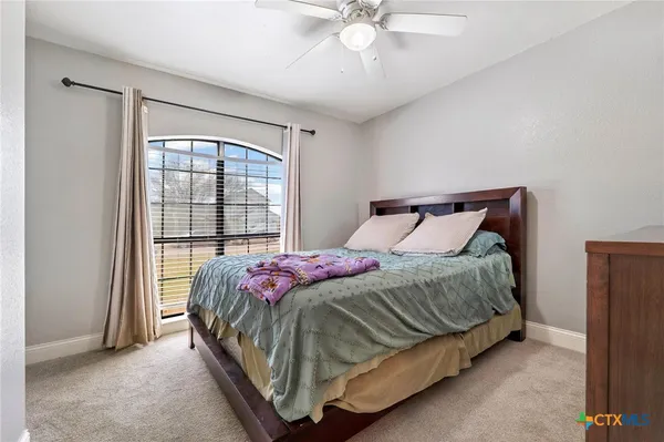 a bedroom with a bed and window