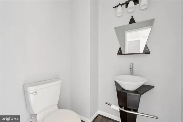 a bathroom with a toilet sink and mirror