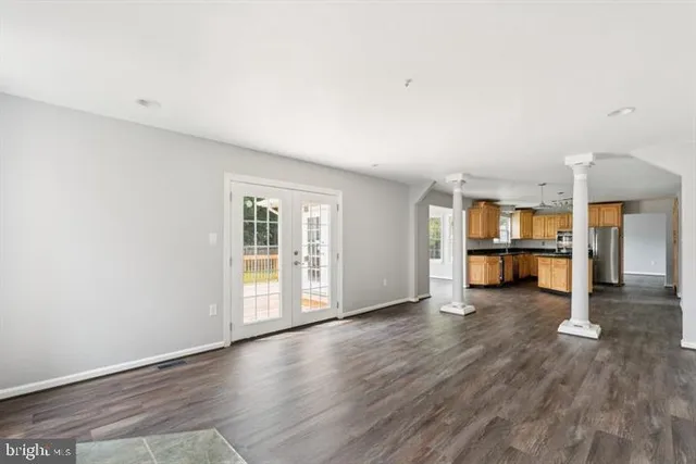 an empty room with wooden floor and door