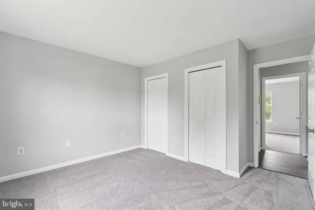 an empty room with closet area