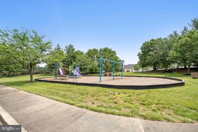 a view of a swimming pool with a lawn chairs and a big yard