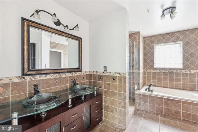 a bathroom with a double vanity sink mirror and