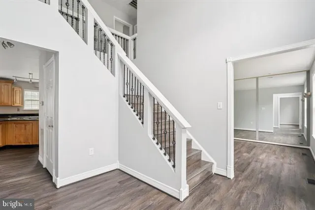 a view of entryway and hall with wooden floor