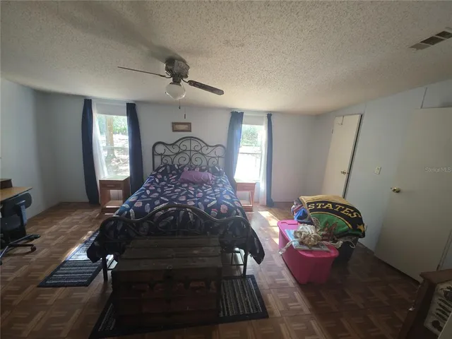 a bedroom with a bed and window