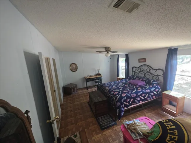 a bedroom with a bed and a mirror on dresser