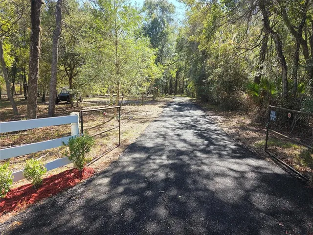 a view of a yard with wooden fence