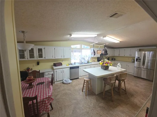a kitchen with a sink appliances and cabinets